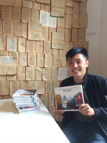 Justin Ng with copies of his book.
