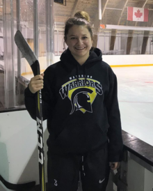 Dollee Meigs at the CIF arena holding a hockey stick.