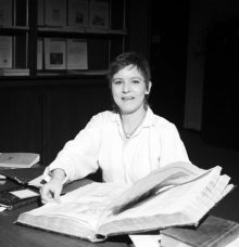 Jane Britton in the 1980s with a large book.