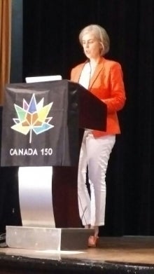 Julia Williams speaks at a podium.