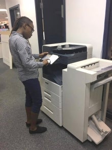 A person uses a new photocopier.