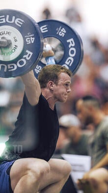 Jack Farlow performs a snatch with barbell weights.