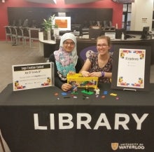 Two students at a Lego Table in the Library.