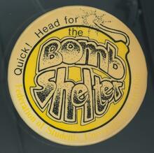 A promotional button for the Bombshelter Pub, circa 1970s.
