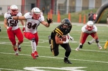 Warriors football player with Guelph team closing in.