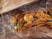 A box of &quot;Here To Help&quot; buttons.