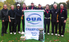 The golf team and coaches celebrate OUA victory.