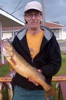Larry Marks holding a fish.