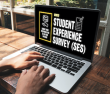 A person uses a laptop with &quot;Student Experience Survey&quot; on the screen.