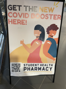 A COVID booster shot poster at the Student Health Pharmacy.