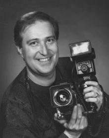Chris Hughes holding a camera.