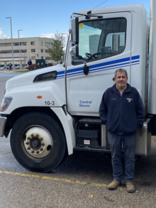 Tony Bairos stands beside a University of Waterloo Central Stores truck.