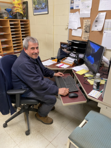 Tony Bairos in his office at his computer.