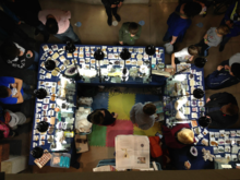 An overhead view of tables laden with gems and minerals.