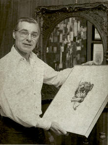 Earl Stieler holds a piece of artwork.