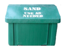 One of the green bins that says &quot;Sand - Use as Needed.&quot;