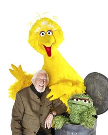 Puppeteer Caroll Spinney with his two alter egos, Big Bird and Oscar the Grouch.