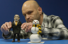 Videographer Matt Regehr positions a President Hamdullahpur puppet during an animation sequence.