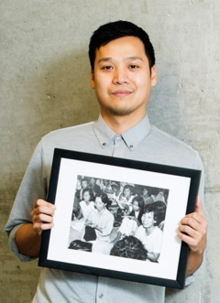 Professor Vinh Nguyen holds a picture of his mother in a Thai refugee camp that he found while researching Southeast Asian refugees.