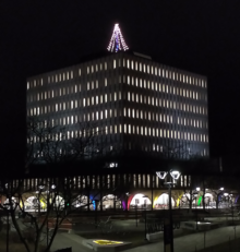 The Davis Centre lit up with a Christmas tree on the roof and holiday lights.