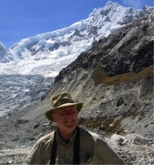 Stephen G. Evans behind a glacial landscape in Peru.