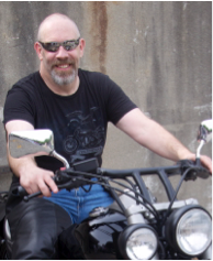 Professor Doug Cowan on a motorcycle.