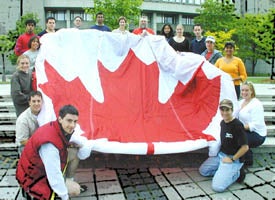 People holding up a Maple Leaf parachute at Canada Day 2001.