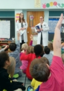 Pharmacy students engage with a class of children.