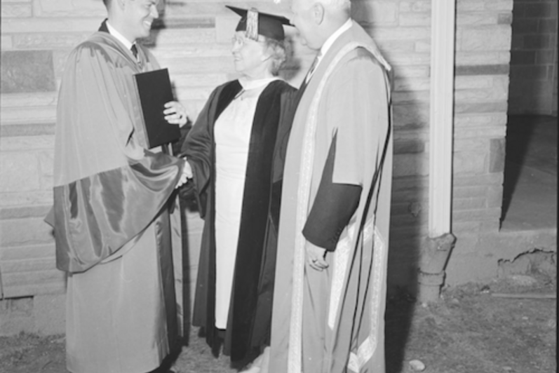 Ronald Mullin wears PhD convocation regalia as he speaks with Dr. Dorothy Turville and President J.G. Hagey