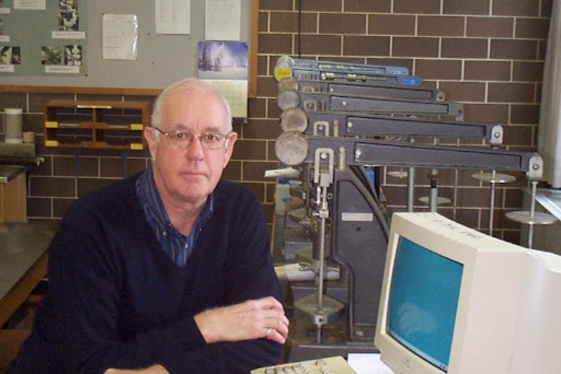 Dr. John Shortreed sits next to a computer.