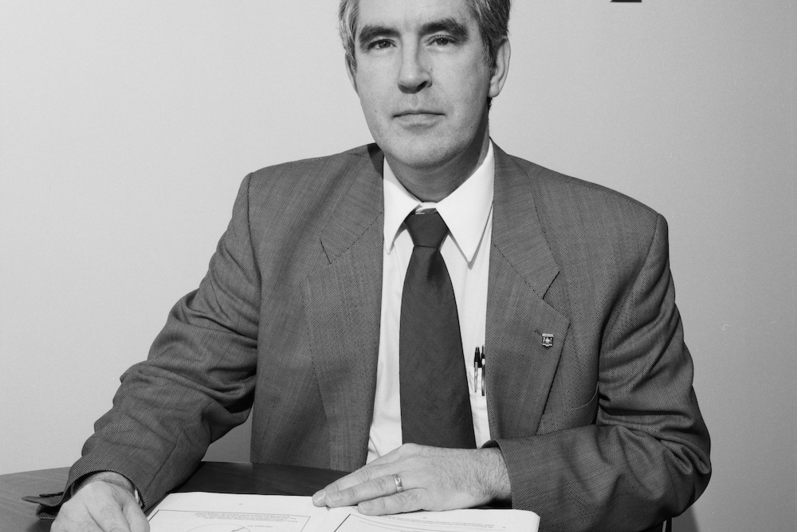 Bob Truman sits at a table in a 1994 photo