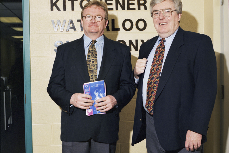 Gary Waller presents a K-W Symphony employee with an award for volunteering in 1997.