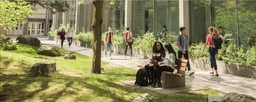 Students walking on campus paths.