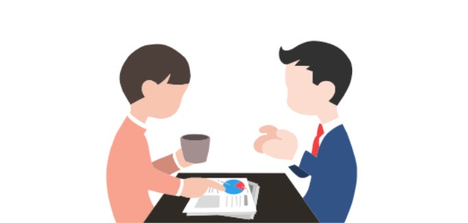 Two people meeting at a desk