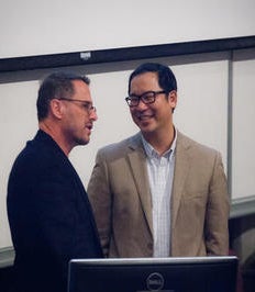 Dr. Alan Ulsifer is introduced at a podium.