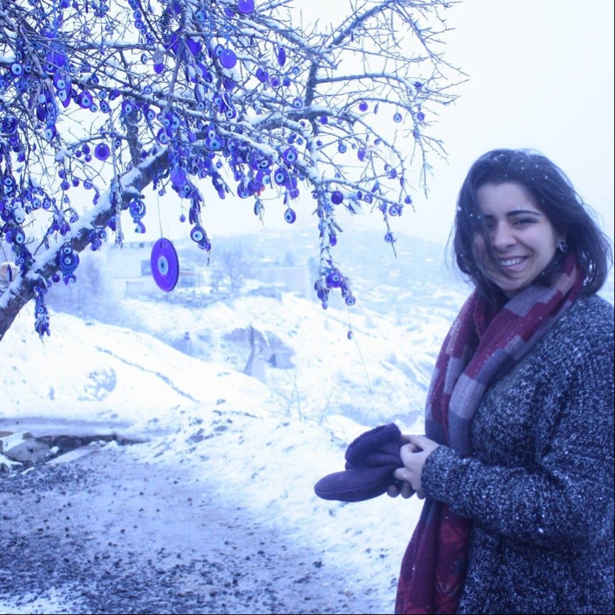 Co-op student Nataly Arar next to a tree in winter.