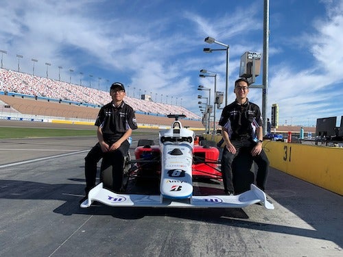 Two Waterloo graduate students with their autonomous racecar.