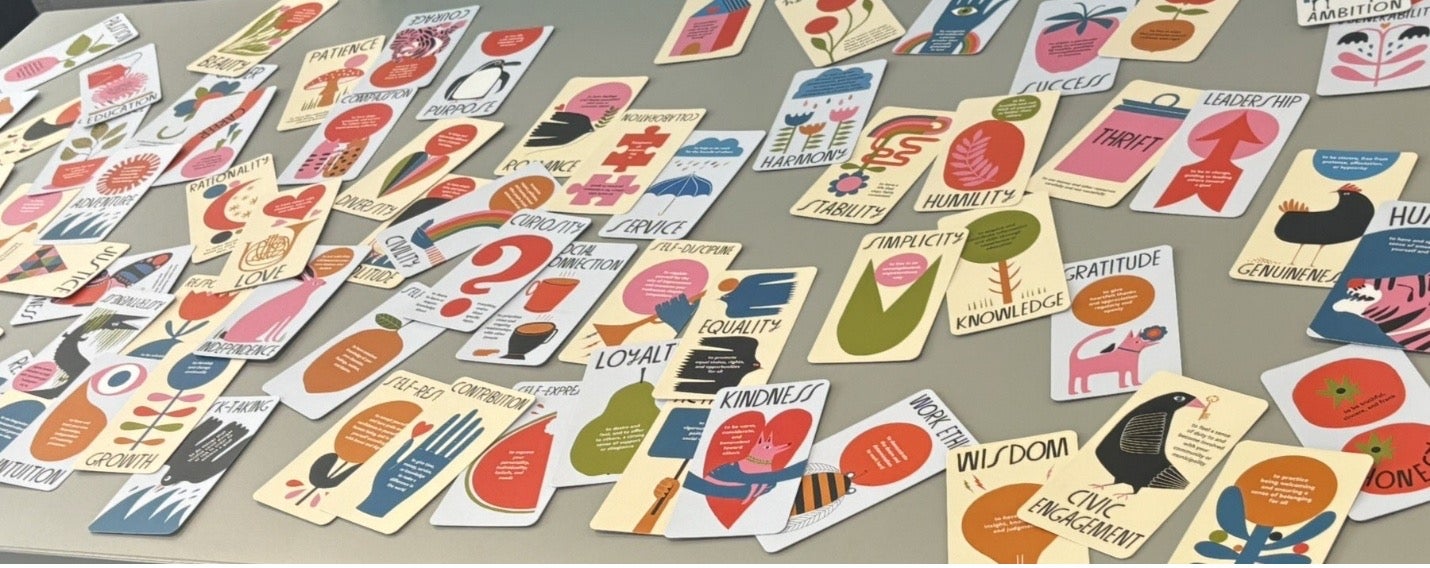 An array of flash cards with words like "humility," "simplicity" and "kindness" printed on them.