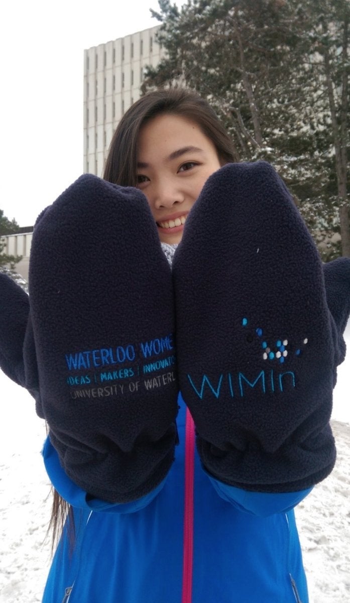 A woman shows off the Waterloo WIMIN mittens.