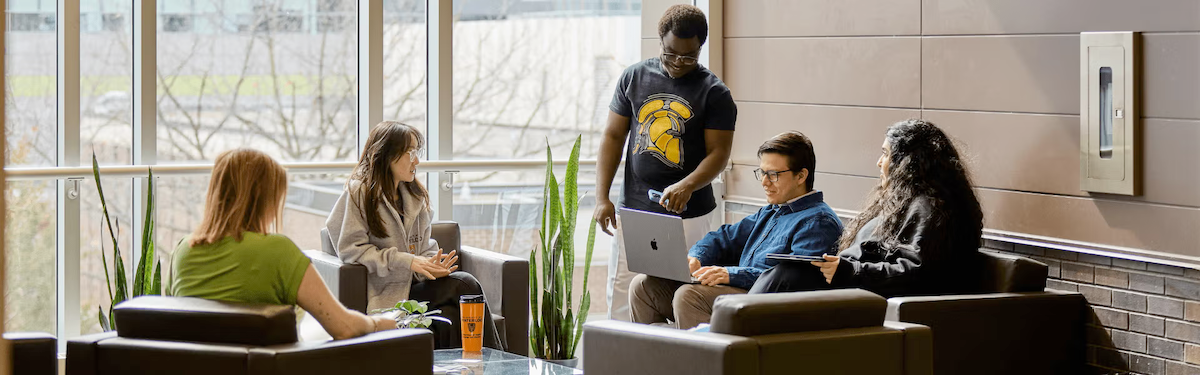 Five grad students in a lounge setting.