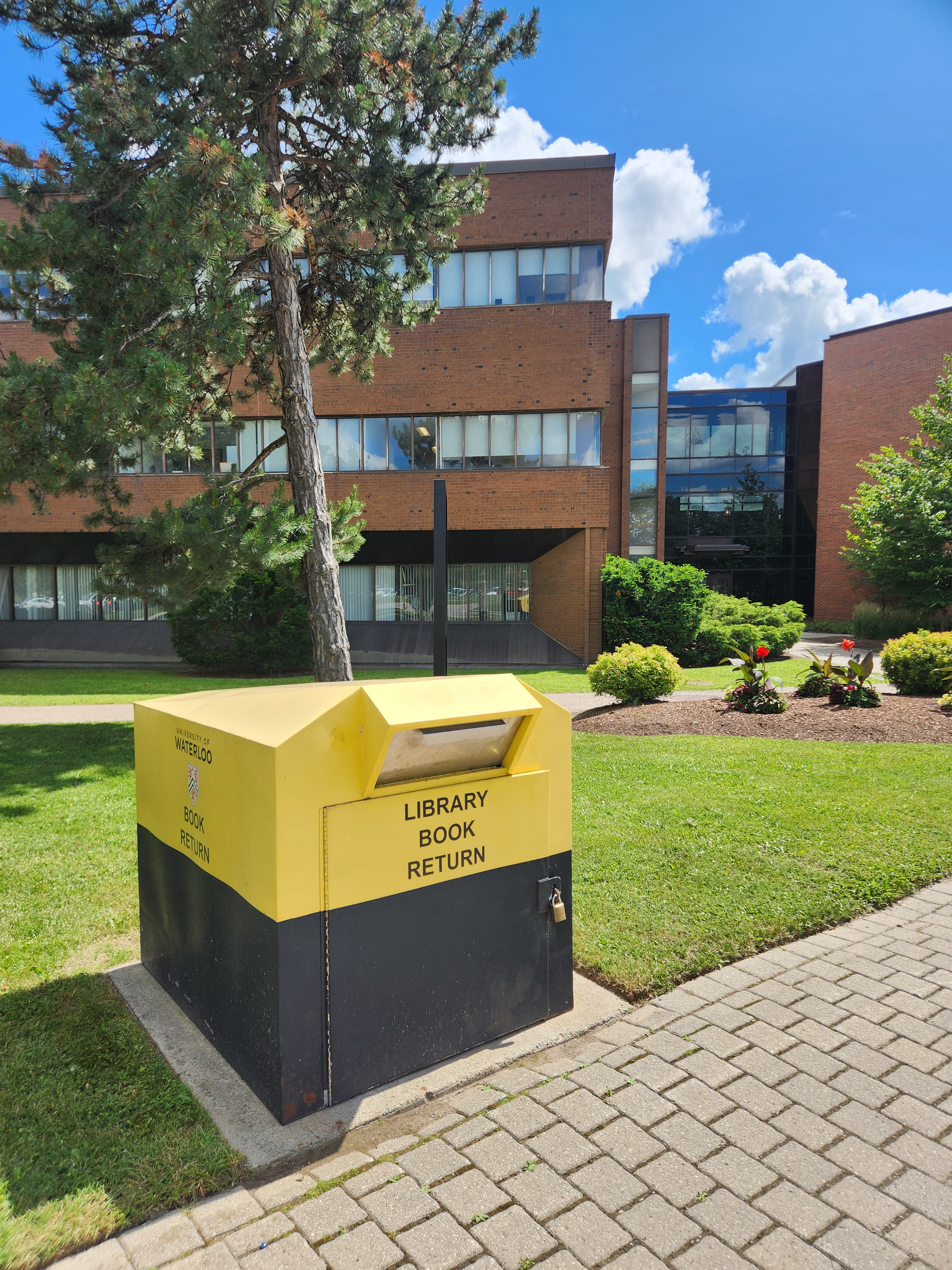 A library book bin drop box near Burt Matthews Hall.