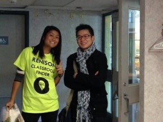 A Renison "Living Map" campus finder with a student.