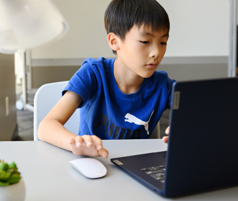 A student works on a laptop.