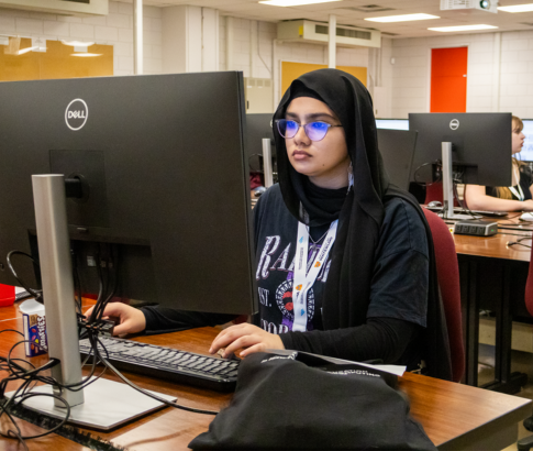 A student works at a computer.