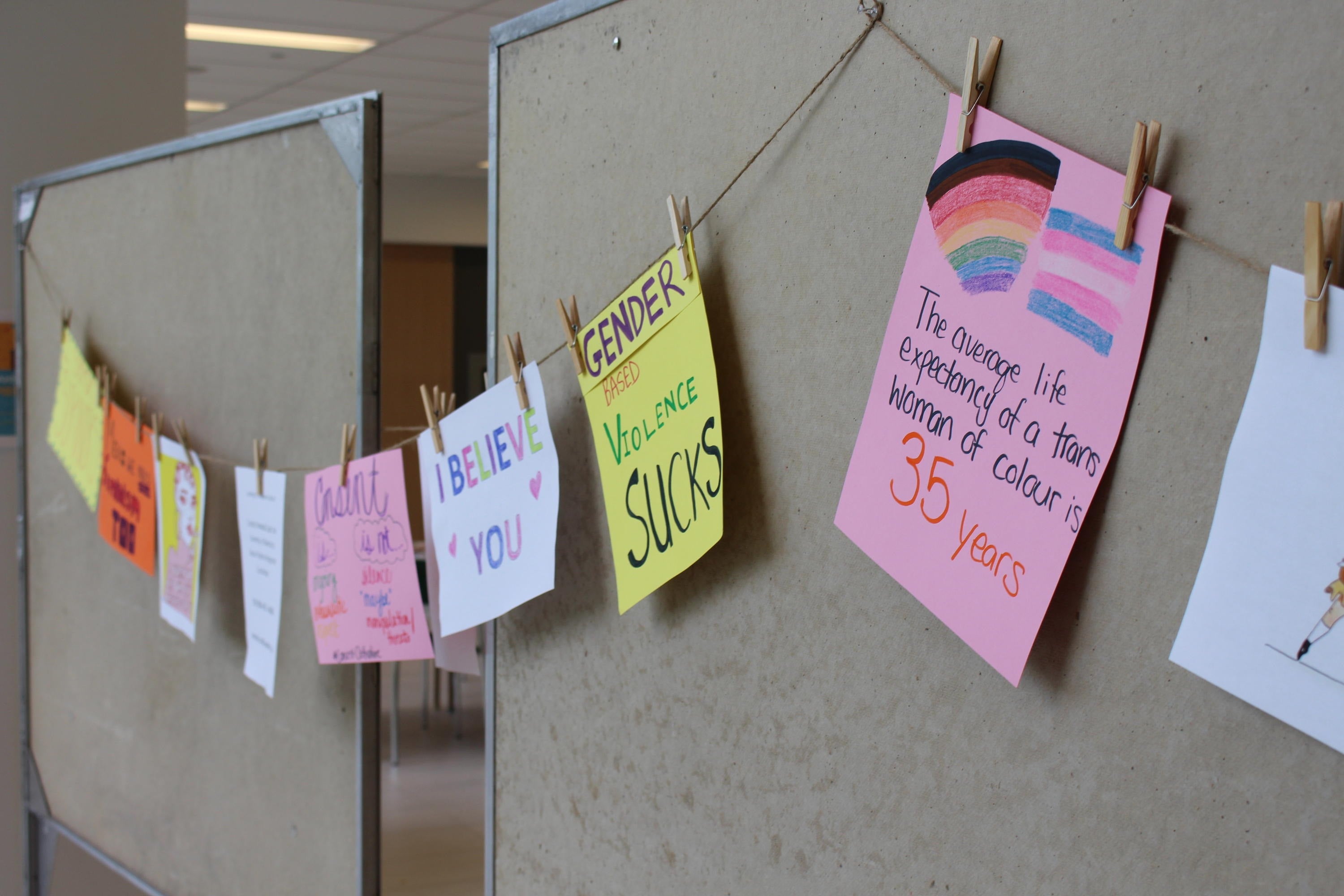 Signs clipped to a clothesline.