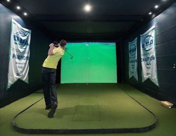 A golf simulator in use.