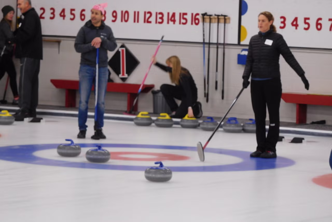 Director of Safety Kate Windsor prepares to sweep an oncoming curling rock.