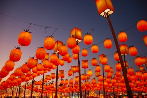 Rows of red paper lanterns on poles and wires.