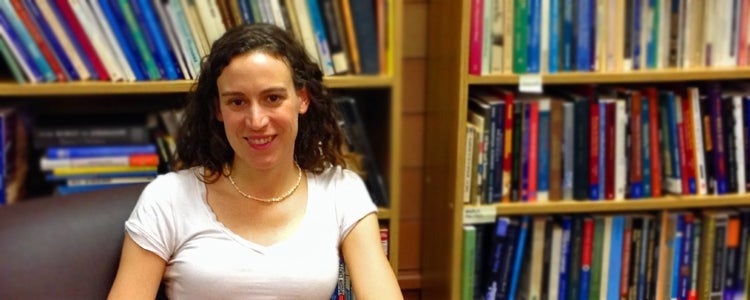 Professor Veronica Kitchen sits in front of bookshelves.