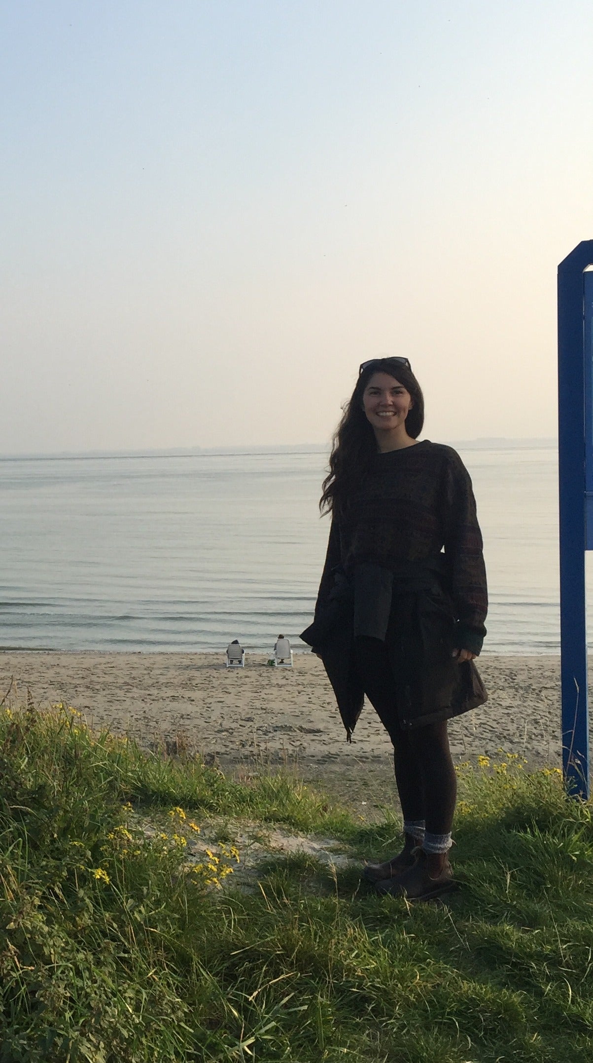 Student Emily Shields stands near the shoreline.